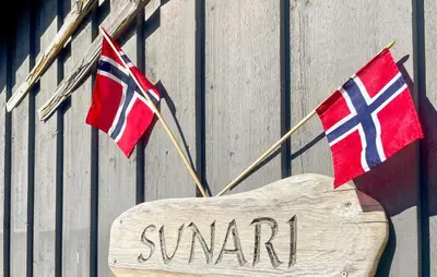 two flags on the side of a building with a sign at Awesome Home In Ustaoset With Wifi in Ustaoset