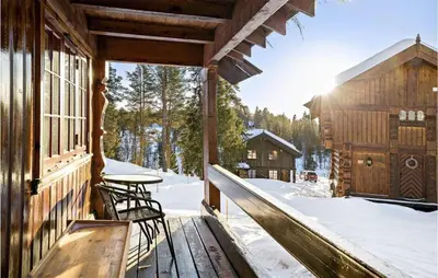 a porch of a log cabin in the snow at 4 Bedroom Nice Home In Rauland in Rauland