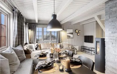 a living room with a couch and a dining room table at 4 Bedroom Nice Home In Rauland in Rauland