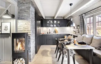 a kitchen with a dining table and a fireplace at 4 Bedroom Nice Home In Rauland in Rauland