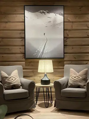 a living room with two chairs and a lamp at Geilo-Kikut, Ski-In, Ski-Out with Stunning Trails and Perfect Location in Geilo