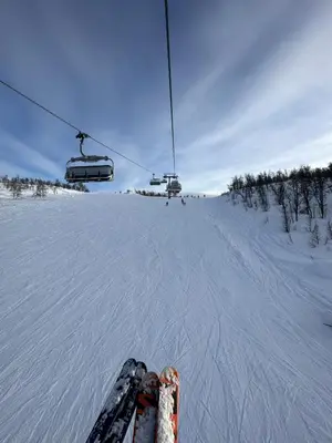 a skier is on a ski lift in the snow at Geilo-Kikut, Ski-In, Ski-Out with Stunning Trails and Perfect Location in Geilo