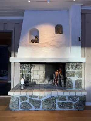 a stone fireplace in a living room with a fire place at Spacious detached house of 209 sqm in the heart of Geilo in Geilo