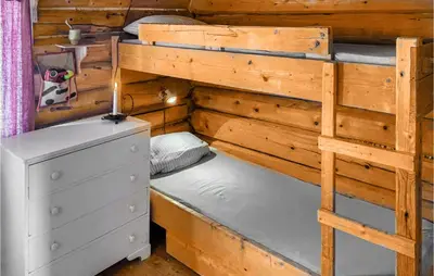a bedroom with two bunk beds and a dresser at Cozy Home In Vinstra With Kitchen in Vinstra