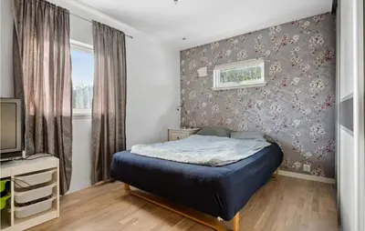 a small bedroom with a bed and a tv at 3 Bedroom Awesome Apartment In Nesttun in Bergen