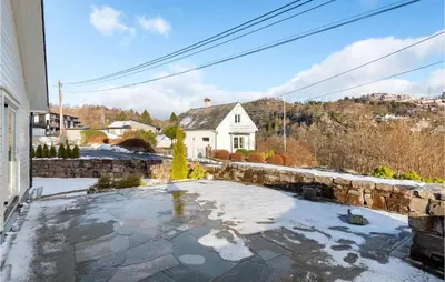 a view of a house with snow on the ground at 3 Bedroom Awesome Apartment In Nesttun in Bergen