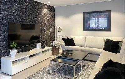 a living room with a white couch and a television at Awesome Home In Olden With Wifi in Olden