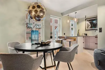 a dining room with a table and chairs at Bryggen Living in Bergen