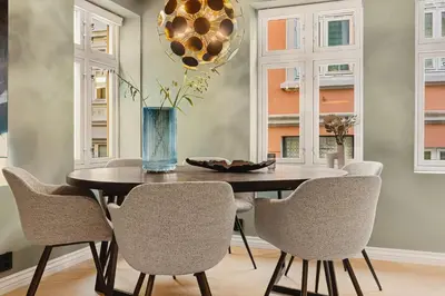 a dining room with a table and chairs at Bryggen Living in Bergen
