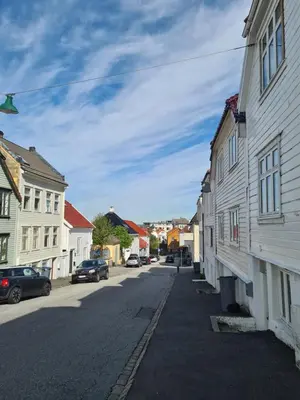 an empty street in a small town with buildings at Fløyen Townhouse in Bergen