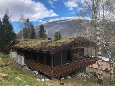 an old house with grass on the roof of it at Olden by the fjords of Norway, Bjørkelund in Stryn