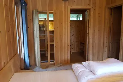 a room with a bed in a room with wooden walls at Olden by the fjords of Norway, Bjørkelund in Stryn
