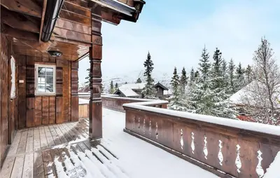 a balcony of a wooden house with snow on it at Beautiful Home In Rjukan With Sauna in Rjukan