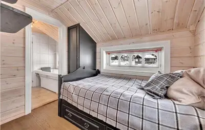 a bedroom with a bed in a room with wooden ceilings at Beautiful Home In Rjukan With Sauna in Rjukan