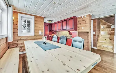 a dining room with a large wooden table and chairs at Beautiful Home In Rjukan With Sauna in Rjukan