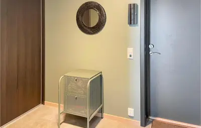 a room with a fan and a door and a mirror at Cozy Apartment In Lillehammer With Wifi in Lillehammer