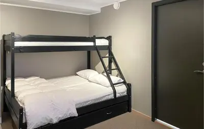 a bedroom with a bunk bed with white sheets at Cozy Apartment In Lillehammer With Wifi in Lillehammer