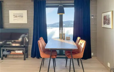 a table and chairs in a room with a window at Cozy Apartment In Lillehammer With Wifi in Lillehammer