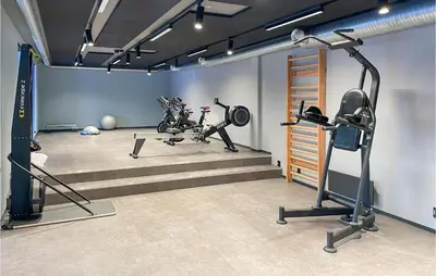 a gym with several tread machines in a room at Cozy Apartment In Lillehammer With Wifi in Lillehammer