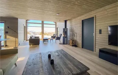 a living room with a couch and a table at Nice Home In Edland With Wifi