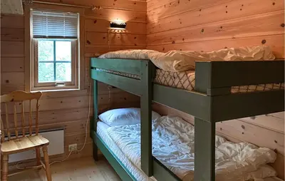 a bedroom with two bunk beds in a log cabin at 2 Bedroom Cozy Home In Lauvstad in Lauvstad