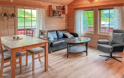 a living room with a couch and a table at 2 Bedroom Cozy Home In Lauvstad in Lauvstad