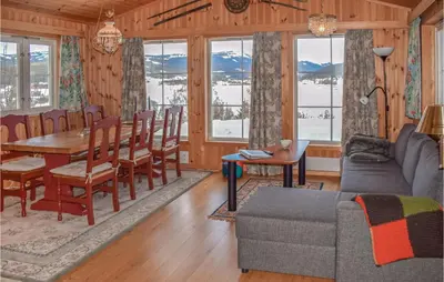a living room with a couch and a table and chairs at Gorgeous Home In Noresund With Wifi in Noresund