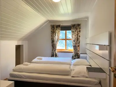 a bedroom with two beds in front of a window at Flåm Holiday Home in Flåm