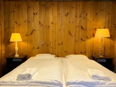 a bedroom with two beds with two lamps on both sides at Flåm Holiday Home in Flåm