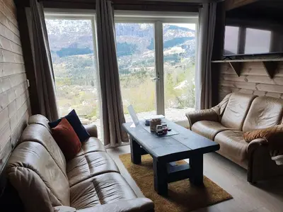 a living room with a couch and a coffee table at Molden 1 - med Jacuzzi! in Luster