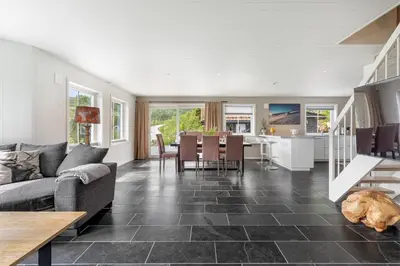 a living room with a couch and a table at Grand and modern cabin in Sogndal