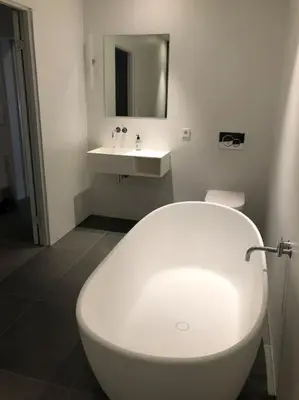 a bathroom with a white toilet and a sink at Storlauvøya The Atlantic Ocean Road in Karvåg