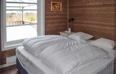 two large beds in a bedroom with a window at Nice Home In Hemsedal With Sauna in Hemsedal