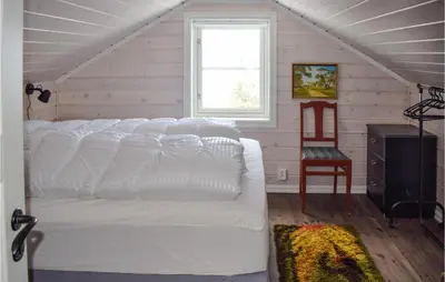 a white bed in a room with a window at Nice Home In Hemsedal With Sauna in Hemsedal