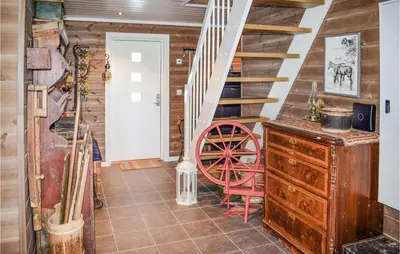 a room with a staircase and a red wheel at Nice Home In Hemsedal With Sauna in Hemsedal