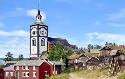 a church with a tower with a clock on it at 3 Bedroom Cozy Home In Røros in Røros