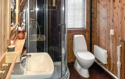 a bathroom with a toilet and a shower and a sink at 3 Bedroom Cozy Home In Røros in Røros
