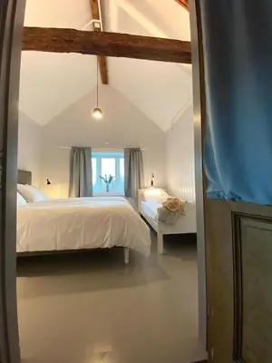 a bedroom with a large bed and a window at Storsand Gård in Trondheim