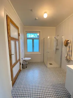 a bathroom with a shower and a toilet and a sink at Storsand Gård in Trondheim