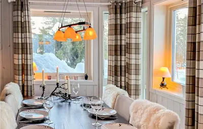 a dining room with a table with wine glasses at Beautiful Home In Noresund With Wifi in Noresund