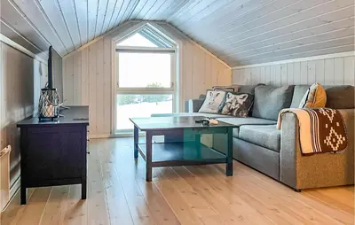 a living room with a couch and a table at Beautiful Home In Noresund With Wifi in Noresund