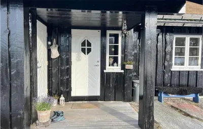 a black house with a white door and a window at Nice Home In Veggli With Wifi in Veggli