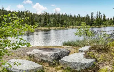 two large rocks sitting next to a lake at Nice Home In Veggli With Wifi in Veggli