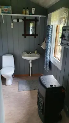 a bathroom with a toilet and a sink at Cozy log cabin at beautiful Nystølsfjellet in Gol