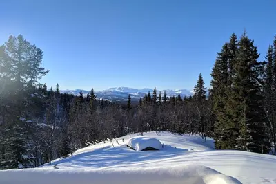 a snow covered slope with an igloo on a mountain at Cozy log cabin at beautiful Nystølsfjellet in Gol