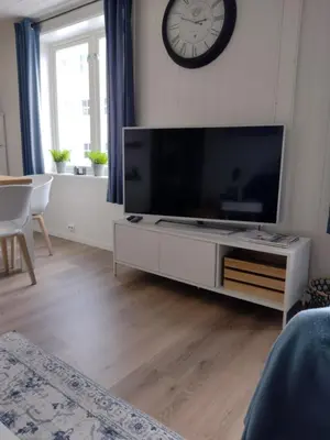 a living room with a large flat screen tv at Light home apartment Alesund with free parking in Ålesund