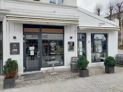 a store front with two potted plants in front of it at Bergen city center apartment in Bergen