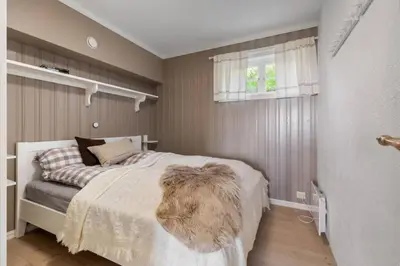 a bedroom with a bed with a furry blanket on it at Bjødnabakkens innbydende in Beitostøl