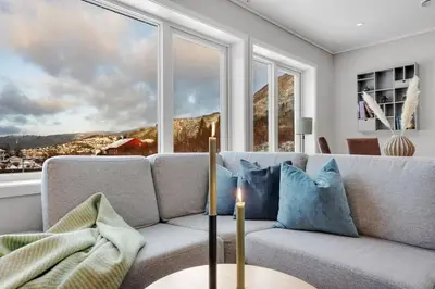 a living room with a couch and a large window at Stor og moderne leilighet i Indre Arna Bergen GRATIS PARKERING!! in Bergen