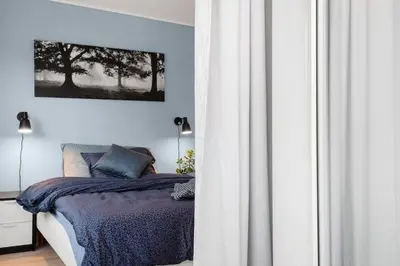 a bedroom with a bed with a blue comforter at Stor og moderne leilighet i Indre Arna Bergen GRATIS PARKERING!! in Bergen